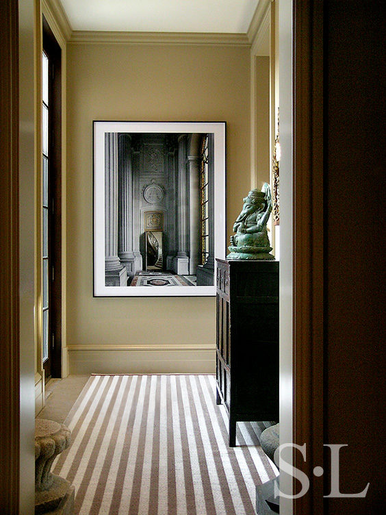 Hallway with striped rug and artwork by Robert Polidori