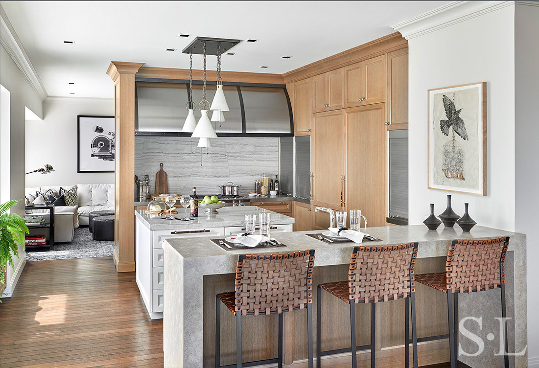 Chicago residence kitchen with light-colored rift-cut oak millwork, marble and stainless steel designed by Suzanne Lovell Inc.