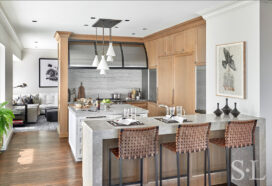 Chicago residence kitchen with light-colored rift-cut oak millwork, marble and stainless steel designed by Suzanne Lovell Inc.