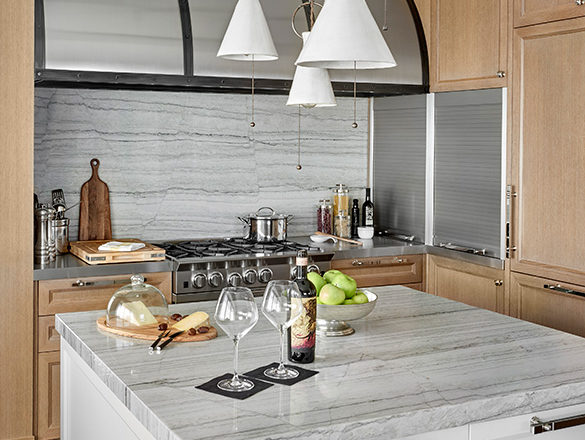 Chicago residence kitchen with light-colored rift-cut oak millwork, marble and stainless steel with ceramic pendant light fixture over center island