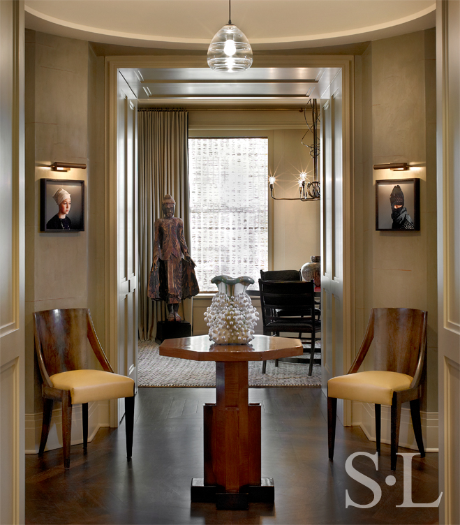 Chicago high-rise apartment rotunda with hand-blown glass pendant lamp and ceramic vessel by Kate Malone