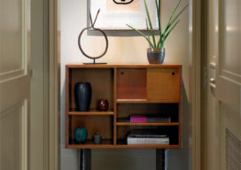 Chicago high-rise apartment hallway showing a Matisse hanging above a mid-century cabinet by Le Corbusier and Charlotte Perriand