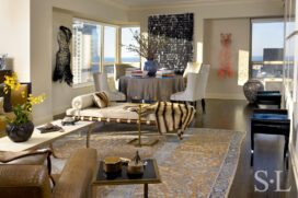 Chicago apartment living room view towards dining room featuring artwork by Glenn Ligon and Keysook Geum and a daybed by Mies van der Rohe