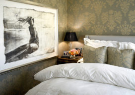 Chicago apartment bedroom with damask upholstered walls and artwork by Greg Lauren