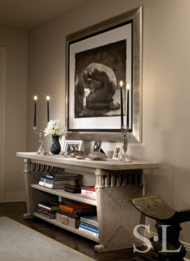 Chicago apartment entryway with console by Christian Astuguevieille and artwork by Greg Lauren