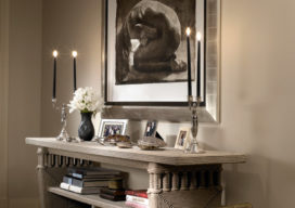 Chicago apartment entryway with console by Christian Astuguevieille and artwork by Greg Lauren