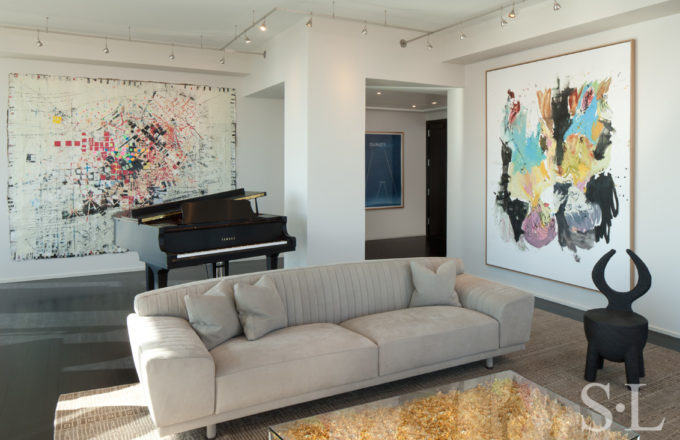 Manhattan residence interior view towards entry with coffee table by Yves Kline, a piano and artwork by Mark Bradford, Ed Ruscha and Georg Baselitz