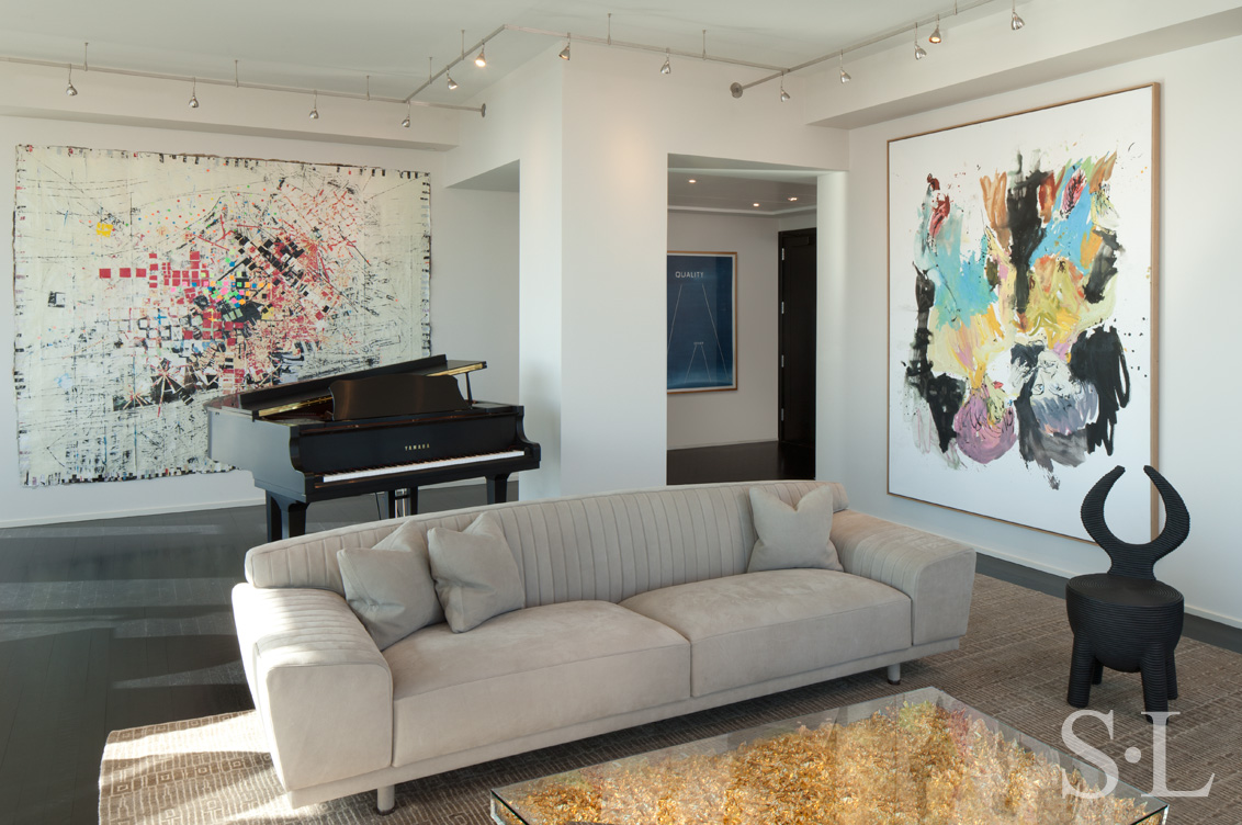 Manhattan residence interior view towards entry with coffee table by Yves Kline, a piano and artwork by Mark Bradford, Ed Ruscha and Georg Baselitz