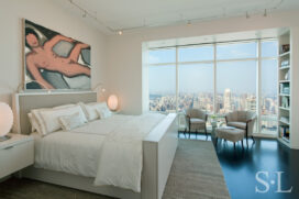 Manhattan residence primary bedroom with white lacquer bed, artwork by Tom Wesselmann and spectacular city view