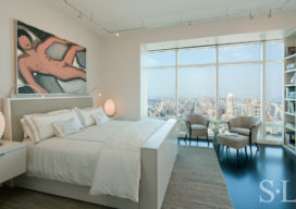 Manhattan residence primary bedroom with white lacquer bed, artwork by Tom Wesselmann and spectacular city view