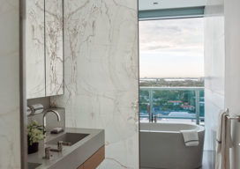 Bathroom view towards soaking tub in Miami Beach penthouse designed by Suzanne Lovell Inc.