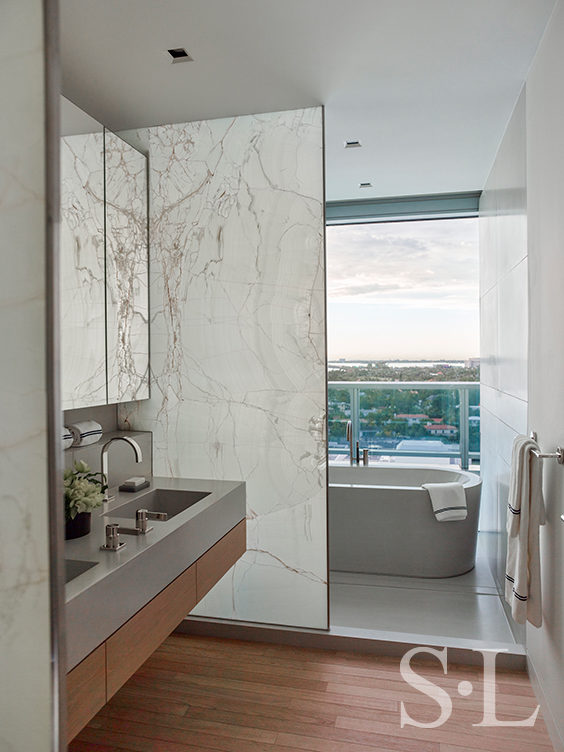 Bathroom view towards soaking tub in Miami Beach penthouse designed by Suzanne Lovell Inc.