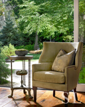 Dining room detail showing chair and table, view to exterior landscaping