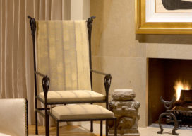 Living room fireplace detail showing chair by Ingrid Donat and Gene Summers andirons