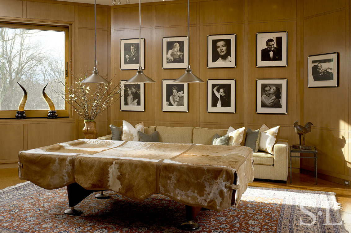 Den with American elm millwork, a grouping of George Hurrell photographs and a pool table with cowhide cover