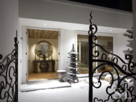 Exterior view of front door, showing French wrought iron entry gates and a Japanese copper pagoda