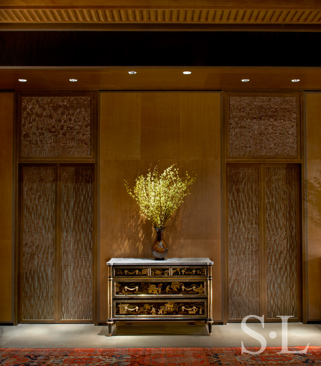 Elevator doors enter to Chicago skyline penthouse made of acrylic panels embedded with copper filament woven on traditional Aubusson rug looms