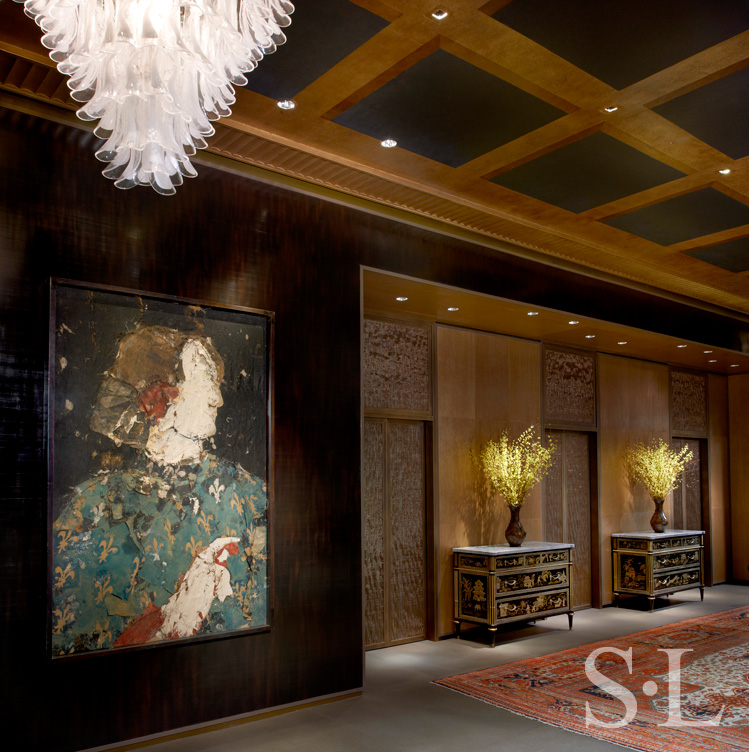 Entry gallery in Chicago skyline penthouse with artwork by Manolo Valdes and Mazzega glass chandelier