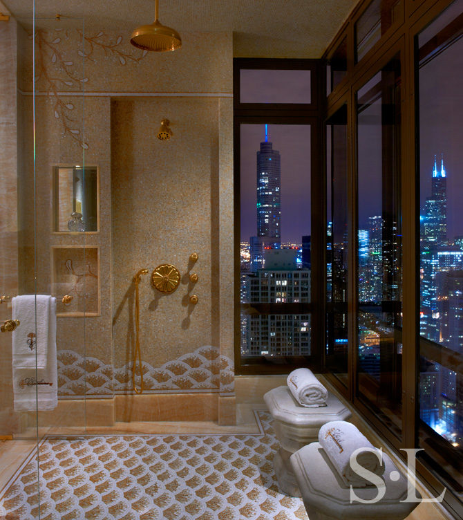Penthouse wet room with honey onyx mosaic and view of Chicago skyline at night