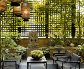Chicago townhome terrace with trellising, a pergola and Asian lanterns