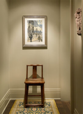 Chicago high-rise apartment hallway showing artwork by Charles Burchfield and an Arts and Crafts runner