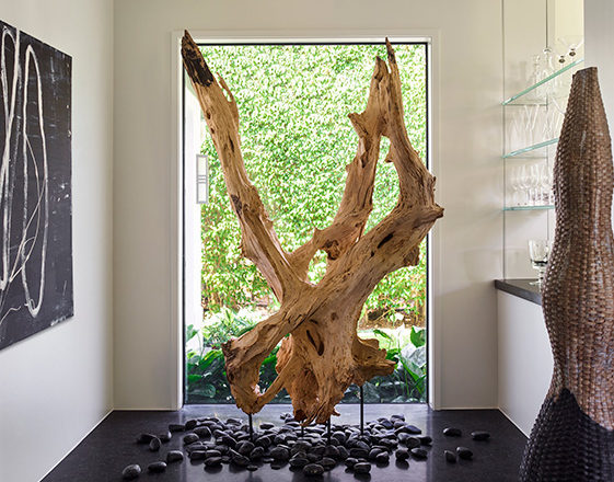 Foyer featuring a sculptural, oversized piece of driftwood