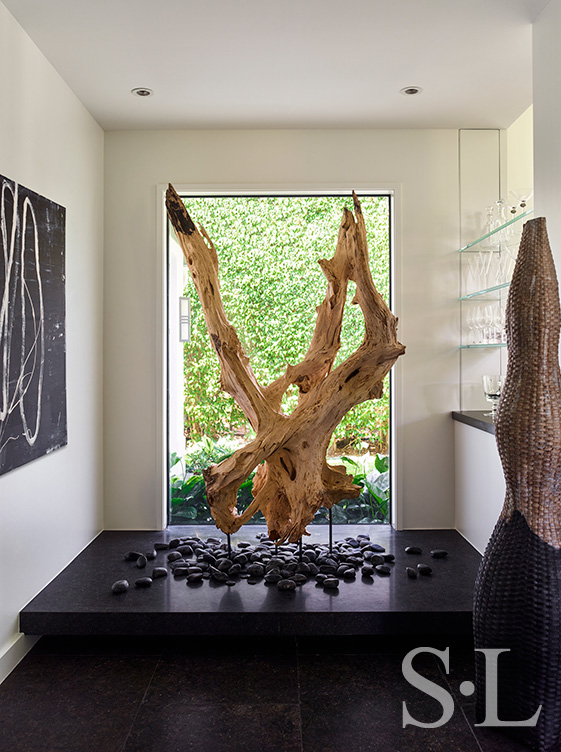 Foyer featuring a sculptural, oversized piece of driftwood