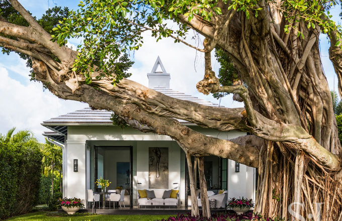 Exterior view of golf cottage in North Palm Beach and majestic banyan tree