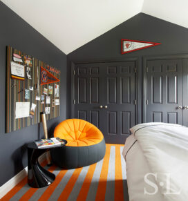 Boy's bedroom designed in grey and orange with sports memorabilia