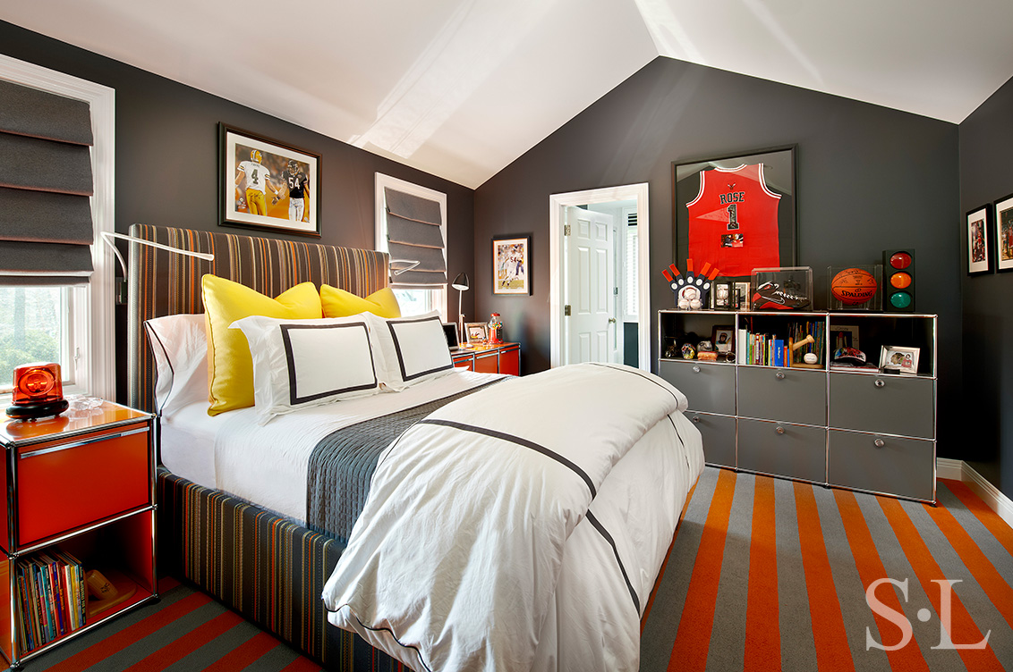 Boy's bedroom designed in grey and orange with sports memorabilia
