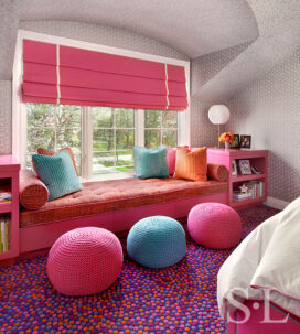 Girls bedroom detail of window seat in pinks and blues