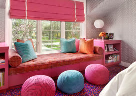 Girls bedroom detail of window seat in pinks and blues