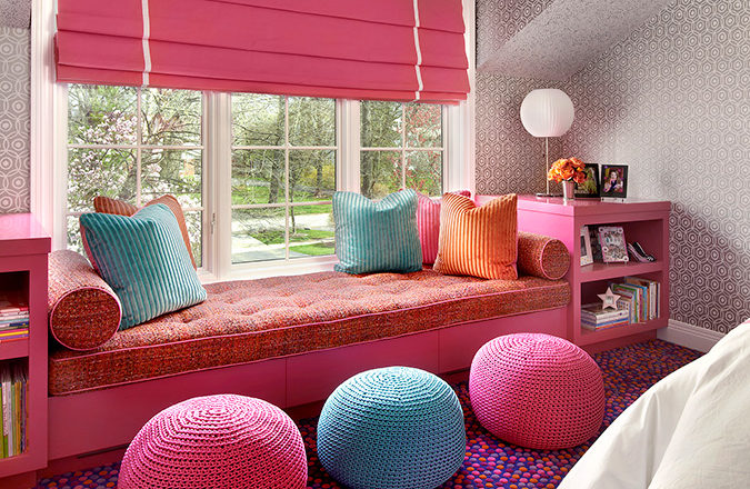 Girls bedroom detail of window seat in pinks and blues