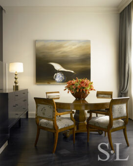 Dining room in waterfront townhome featuring a set of circa 1820 Biedermeier dining chairs and a painting by artist David Kroll