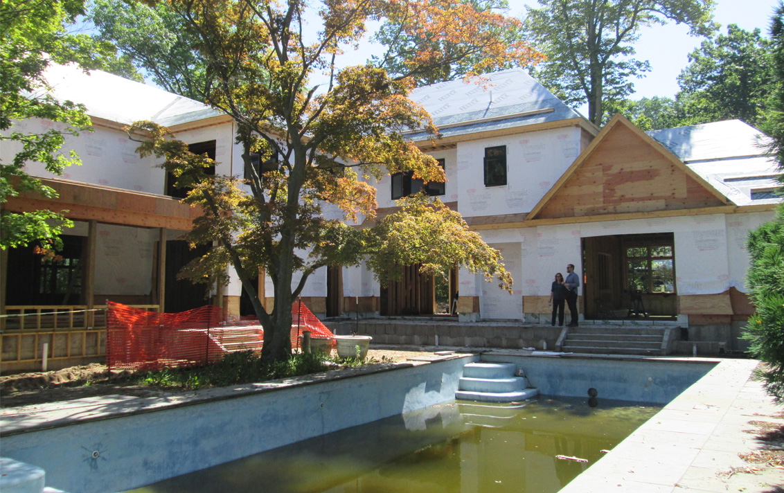 exterior view and pool during construction of lake house in Michigan