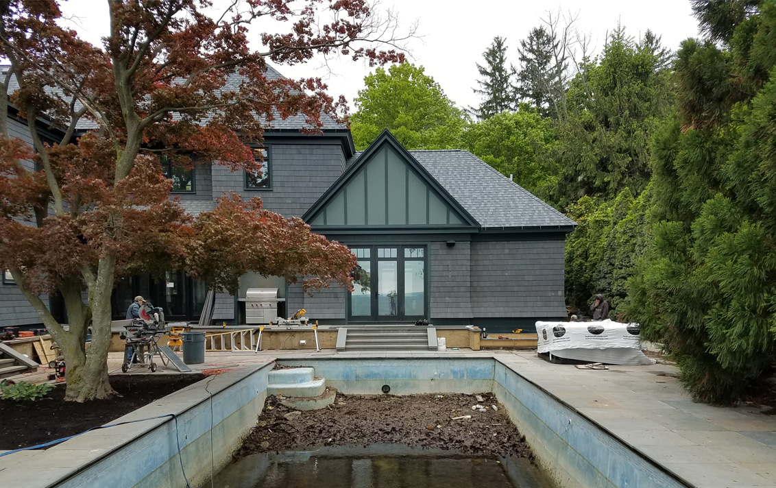 exterior view and pool during construction of lake house in Michigan