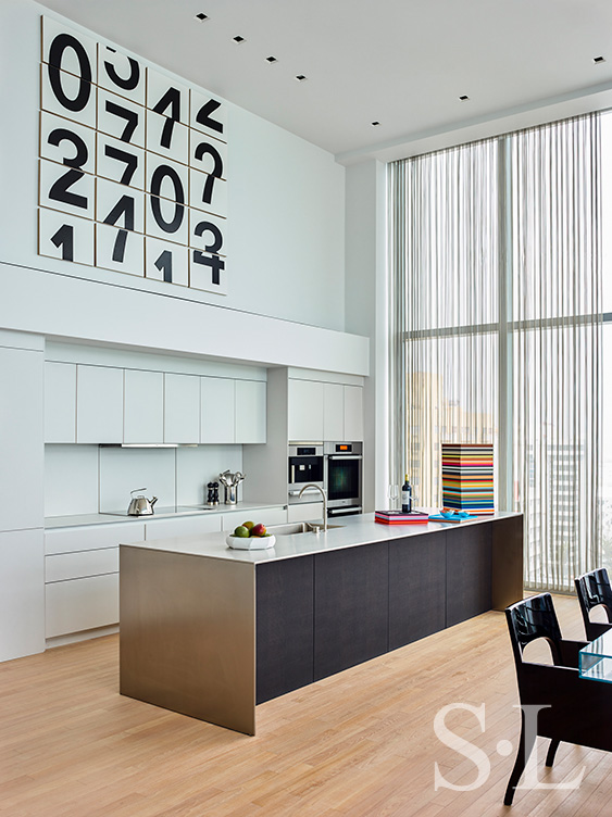 Contemporary kitchen with artwork by Darren Almond and stacked leather trays by Giobagnara Arcobaleno