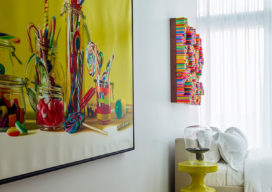 Guest bedroom with artwork by Roberto Bernardi and side table by India Mahdavi