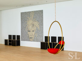 Entry gallery with artwork by Joseph and a set of plywood chairs by Donald Judd