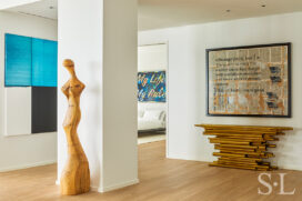 View outside of guest suite with artwork by Callum Innes and a console by Hervé van der Straeten