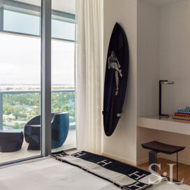 Guest bedroom with surfboard artwork by Michael Dweck