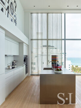 Contemporary kitchen with center island and custom metal chain drapery