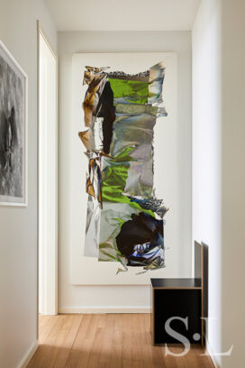 Hallway detail with artwork by Larry Bell and plywood chair by Donald Judd