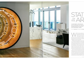 Luxe Magazine spread showing entry and view into living room of Miami Beach penthouse with large scale artwork by Iván Navarro