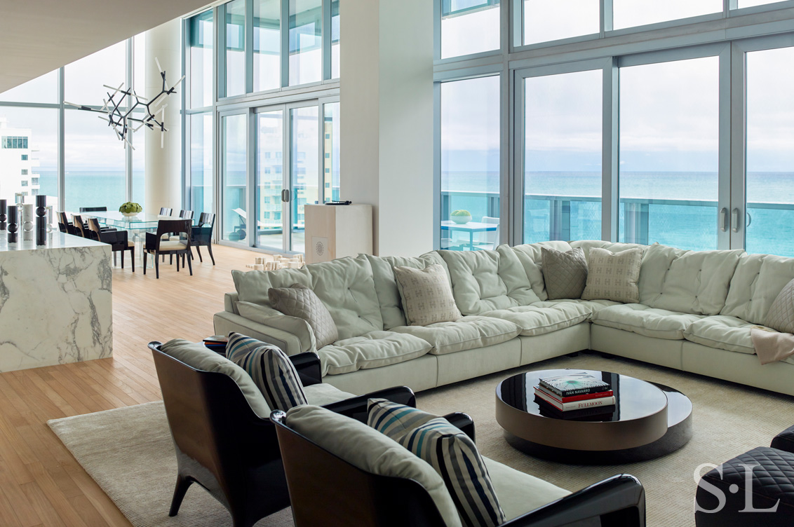 Miami Beach Edition residence great room with full wall of windows facing the ocean, architecture and interior design by Suzanne Lovell Inc.