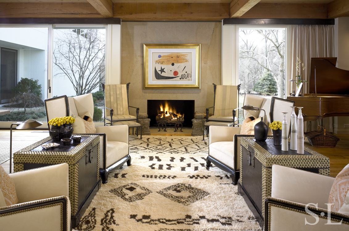 North Shore Chicago contemporary residence living room with fireplace, floor to ceiling windows and artwork by Joan Miró and chairs by Ingrid Donat, architecture and interior design by Suzanne Lovell Inc.