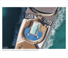 View of Eternity yacht from above with hot tub and black and white striped sun umbrellas