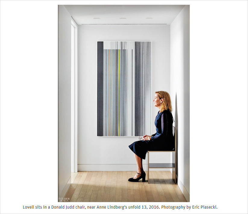 Portrait of Suzanne Lovell seated at end of hall in Donald Judd chair and artwork by Anne Lindberg