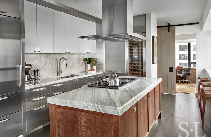 Chicago luxury apartment kitchen designed with natural walnut and stainless steel