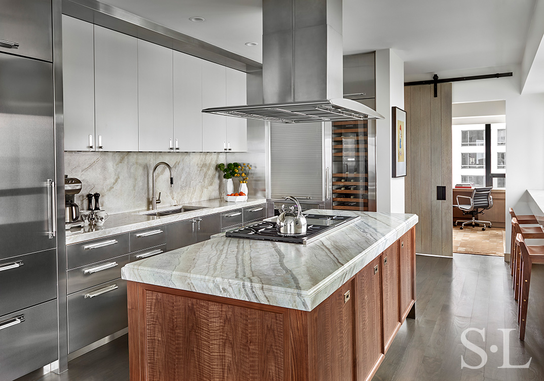 Chicago luxury apartment kitchen designed with natural walnut and stainless steel